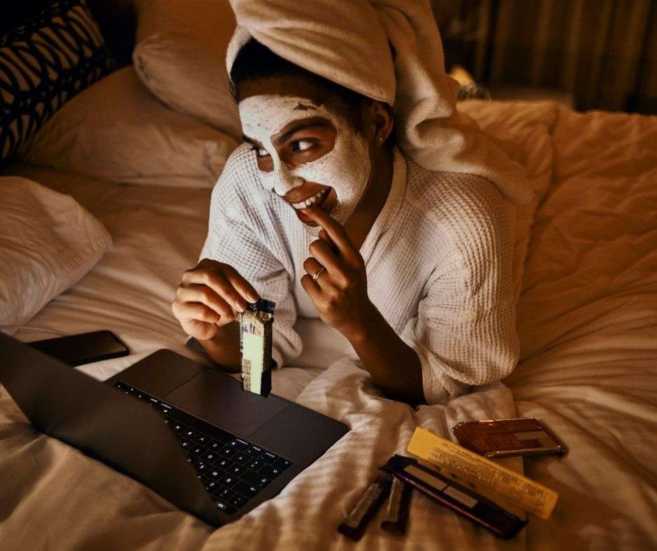woman eating snacks at night on her bed